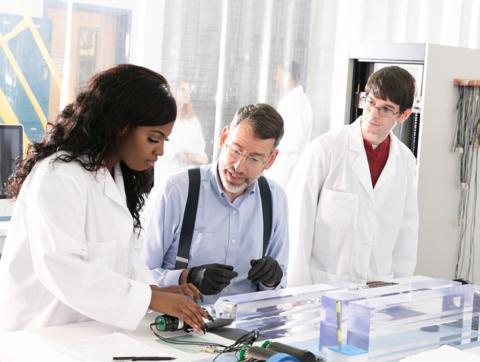 Students with professor in lab